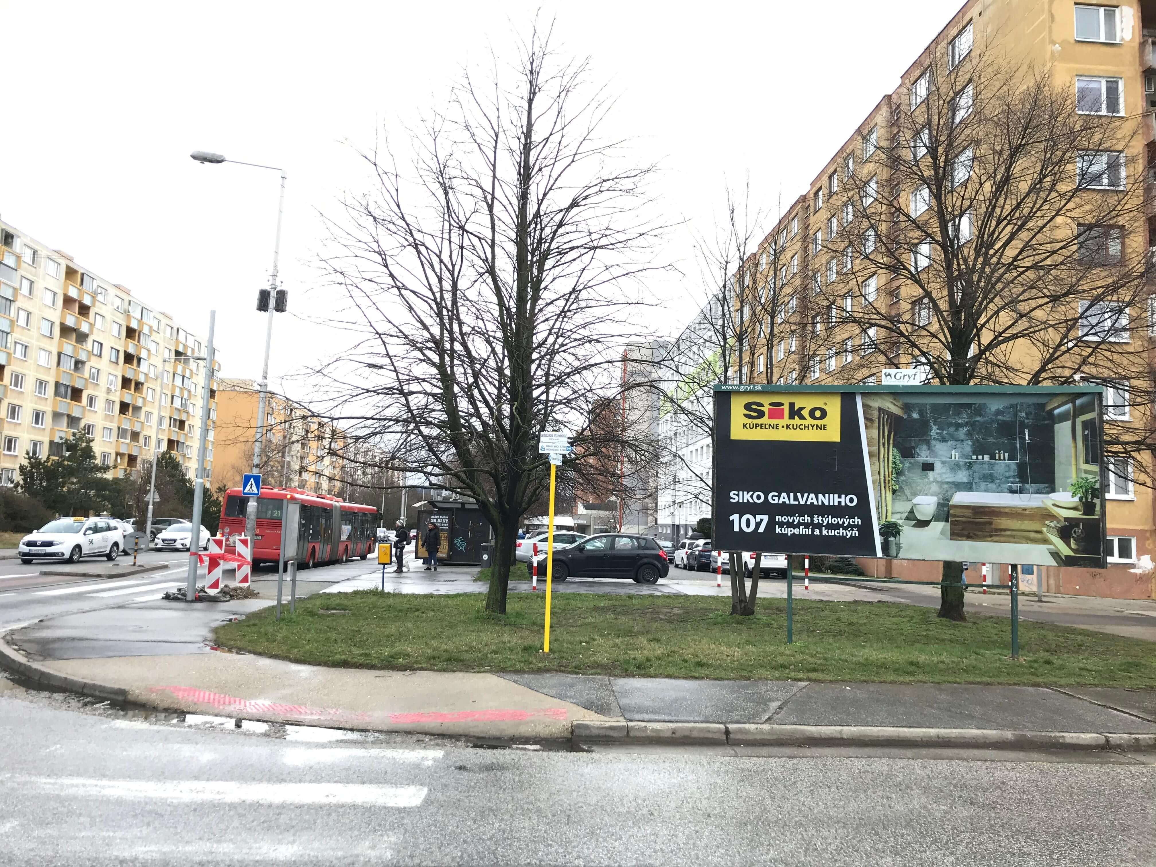 Reklamný billboard v centre mesta so žiarivým dizajnom.